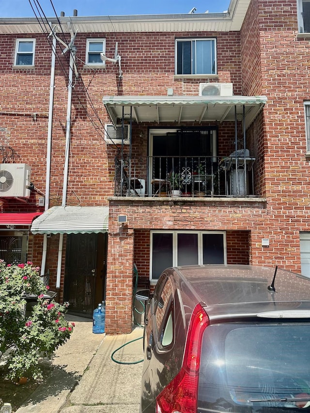 153-15 79th Ave, Flushing, NY 11367 - back of house featuring a balcony and brick siding