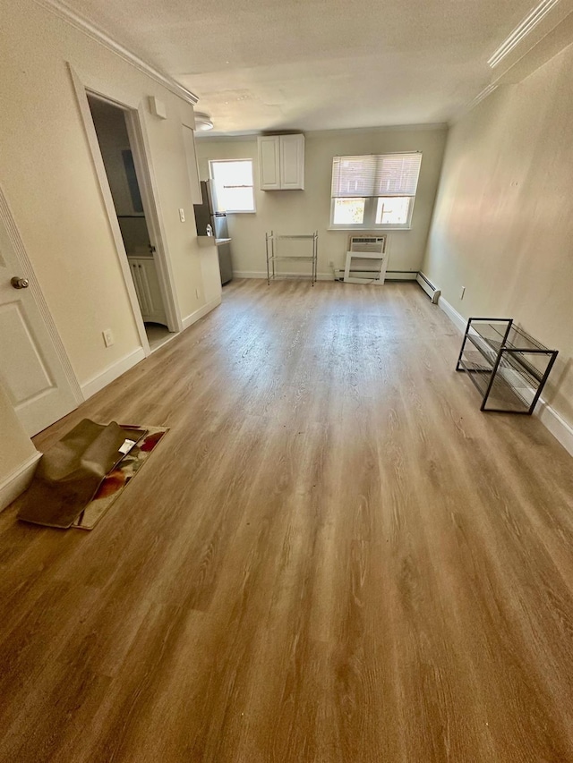153-15 79th Ave, Flushing, NY 11367 - unfurnished living room featuring light wood-type flooring, a wall unit AC, and a textured ceiling