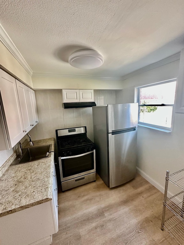 153-15 79th Ave, Flushing, NY 11367 - kitchen featuring appliances with stainless steel finishes, under cabinet range hood, crown molding, white cabinetry, and light countertops