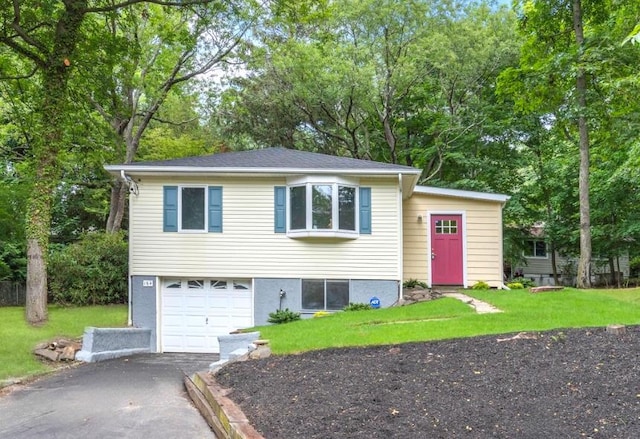 164 Maple Rd, Wading River, NY 11792 - view of front of property featuring asphalt driveway, an attached garage, a front lawn, and view of wooded area