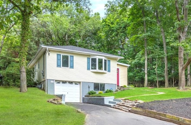 164 Maple Rd, Wading River, NY 11792 - view of front of house featuring asphalt driveway, a front yard, and a garage