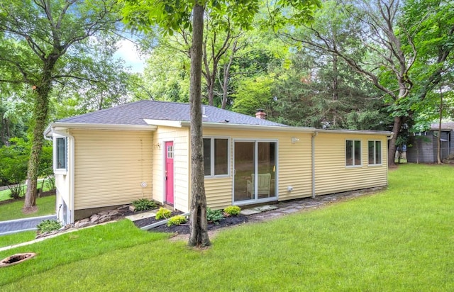 164 Maple Rd, Wading River, NY 11792 - view of front of home with a front lawn, a chimney, and roof with shingles