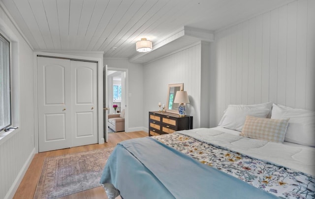 164 Maple Rd, Wading River, NY 11792 - bedroom featuring wood finished floors, wooden ceiling, a closet, wooden walls, and crown molding
