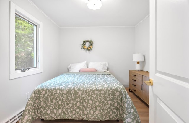 164 Maple Rd, Wading River, NY 11792 - bedroom featuring light wood finished floors, ornamental molding, and baseboard heating