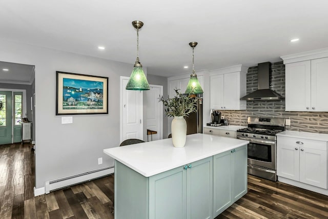10 Garfield Pl, Massapequa, NY 11758 - kitchen with stainless steel range with gas cooktop, a baseboard heating unit, wall chimney range hood, light countertops, and dark wood finished floors