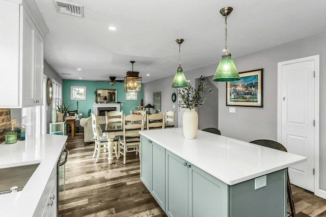 10 Garfield Pl, Massapequa, NY 11758 - kitchen with dark wood finished floors, a breakfast bar, light countertops, and recessed lighting