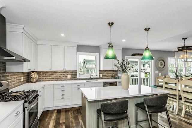 10 Garfield Pl, Massapequa, NY 11758 - kitchen featuring appliances with stainless steel finishes, wall chimney range hood, plenty of natural light, dark wood-style floors, and recessed lighting