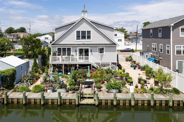 10 Garfield Pl, Massapequa, NY 11758 - back of house with stairs, a fenced backyard, and a deck with water view
