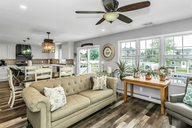 10 Garfield Pl, Massapequa, NY 11758 - living room featuring baseboard heating, dark wood finished floors, a ceiling fan, recessed lighting, and plenty of natural light