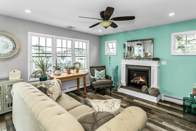10 Garfield Pl, Massapequa, NY 11758 - living room featuring a baseboard heating unit, a glass covered fireplace, healthy amount of natural light, and recessed lighting