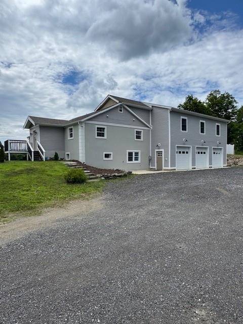 2117 Rte 82, Lagrangeville, NY 12540 - rear view of house with asphalt driveway, a garage, and a deck