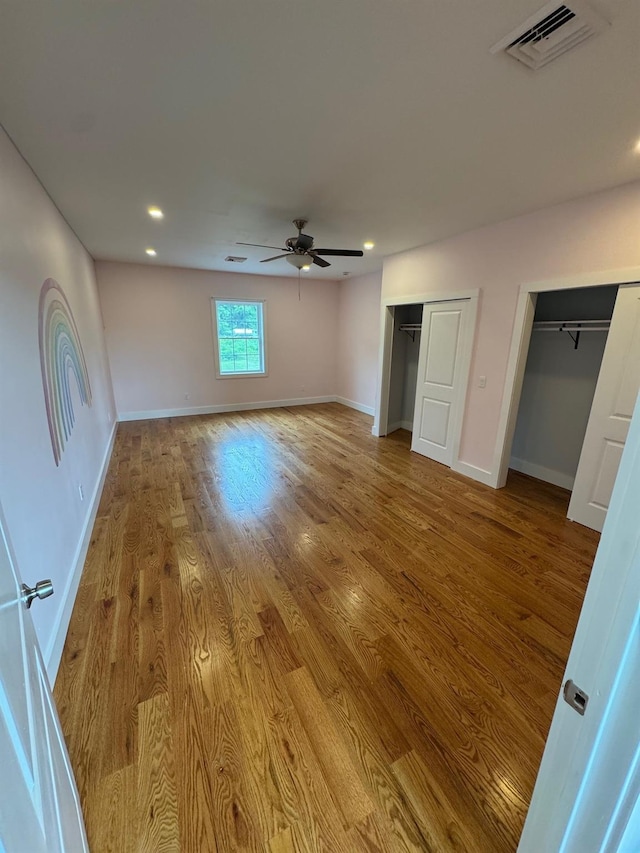 2117 Rte 82, Lagrangeville, NY 12540 - unfurnished bedroom featuring multiple closets, wood finished floors, recessed lighting, and ceiling fan