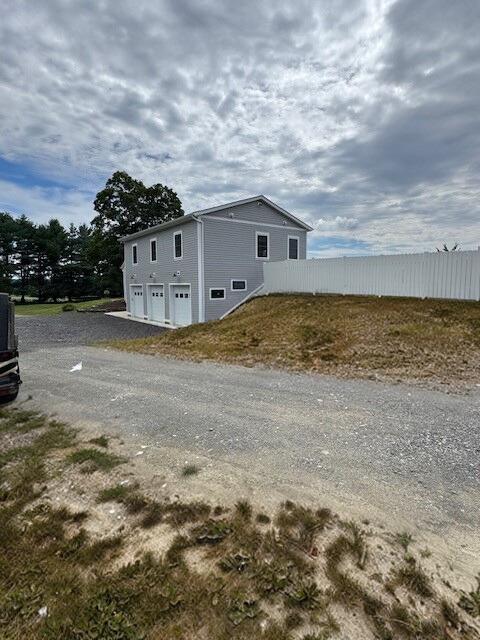 2117 Rte 82, Lagrangeville, NY 12540 - view of side of home featuring an attached garage and driveway