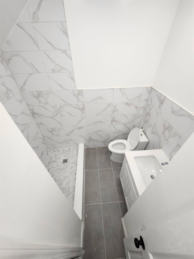 167 Euclid Ave, Brooklyn, NY 11208 - bathroom with tile walls, a stall shower, vanity, and a wainscoted wall