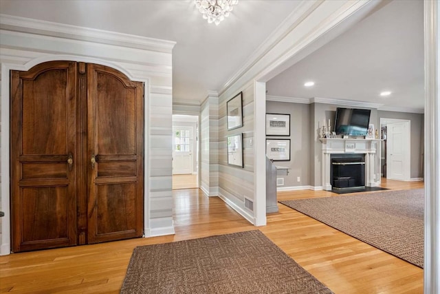 7 Westview Ln, Scarsdale, NY 10583 - foyer entrance with ornamental molding, a fireplace with flush hearth, light wood-style floors, and recessed lighting