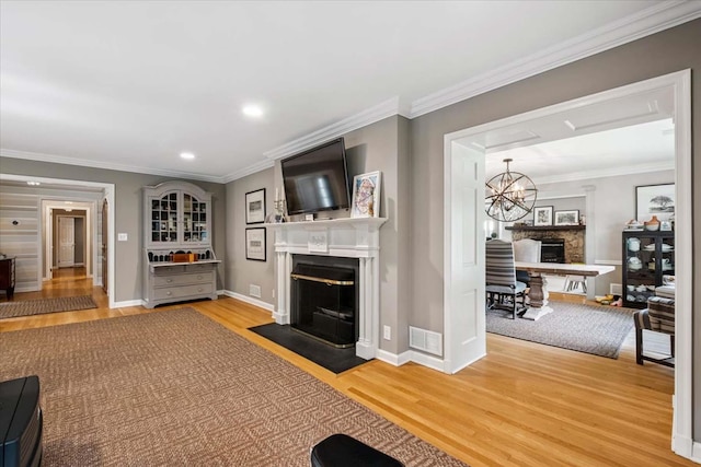 7 Westview Ln, Scarsdale, NY 10583 - living room featuring a fireplace with flush hearth, wood finished floors, ornamental molding, and recessed lighting