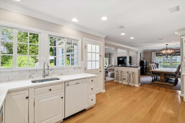 7 Westview Ln, Scarsdale, NY 10583 - kitchen featuring white dishwasher, ornamental molding, a chandelier, tasteful backsplash, and white cabinetry