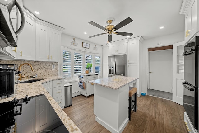 24 Border Ln, Levittown, NY 11756 - kitchen with stainless steel refrigerator with ice dispenser, ceiling fan, white cabinets, and recessed lighting