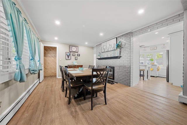 24 Border Ln, Levittown, NY 11756 - dining space featuring baseboard heating, wood finished floors, a fireplace, recessed lighting, and ornamental molding