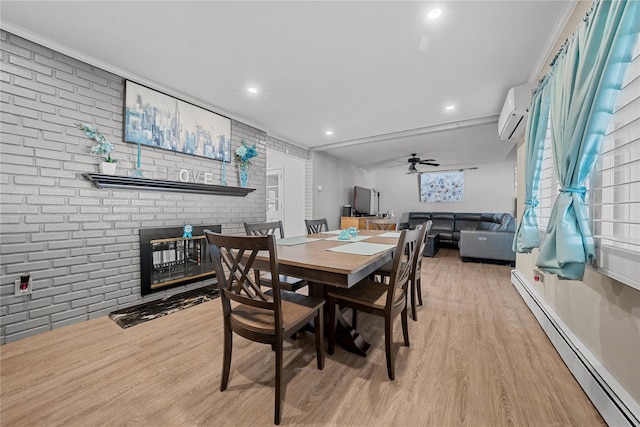 24 Border Ln, Levittown, NY 11756 - dining space with a baseboard heating unit, a brick fireplace, a wall mounted AC, wood finished floors, and brick wall