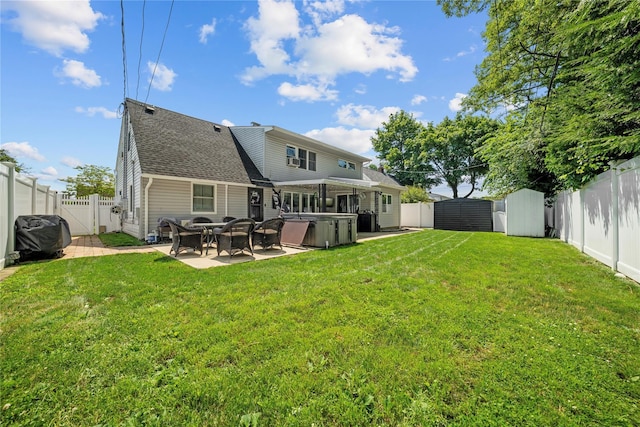 24 Border Ln, Levittown, NY 11756 - rear view of property with a hot tub, a patio, a fenced backyard, a storage shed, and roof with shingles