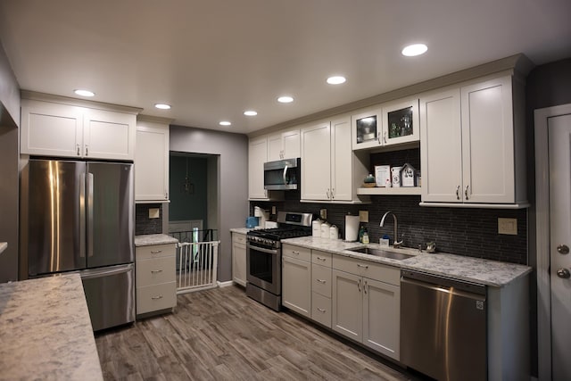 21 Edgebrook Ln, Airmont, NY 10952 - kitchen featuring appliances with stainless steel finishes, tasteful backsplash, dark wood-type flooring, white cabinetry, and recessed lighting