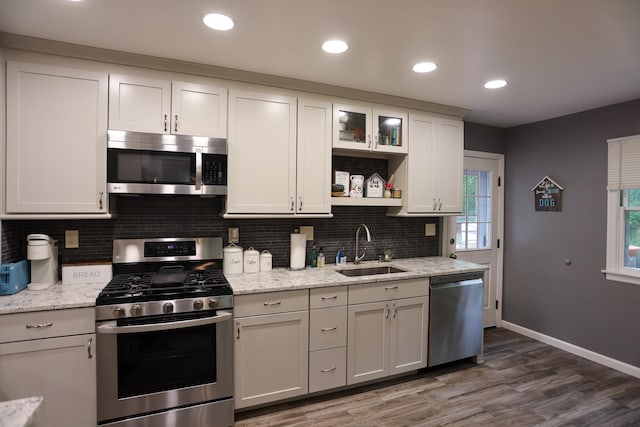 21 Edgebrook Ln, Airmont, NY 10952 - kitchen with stainless steel appliances, decorative backsplash, wood finished floors, open shelves, and light stone counters
