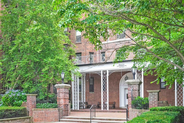 84-51 Beverly Rd Unit 5P, Kew Gardens, NY 11415 - view of front of house with brick siding, covered porch, and a balcony