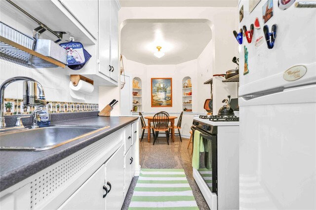 84-51 Beverly Rd Unit 5P, Kew Gardens, NY 11415 - kitchen with freestanding refrigerator, gas range oven, dark countertops, and white cabinetry