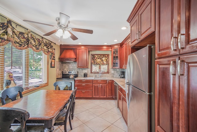 2772 Cypress Ave, East Meadow, NY 11554 - kitchen with appliances with stainless steel finishes, custom range hood, a ceiling fan, light tile patterned floors, and decorative backsplash