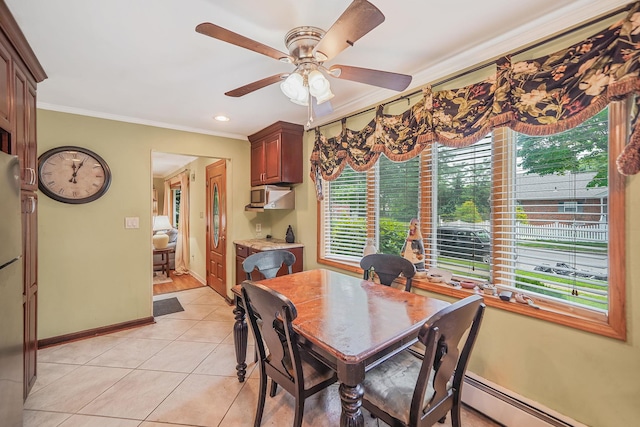 2772 Cypress Ave, East Meadow, NY 11554 - dining space featuring ornamental molding, a baseboard heating unit, healthy amount of natural light, light tile patterned floors, and a ceiling fan