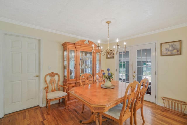 2772 Cypress Ave, East Meadow, NY 11554 - dining space featuring a chandelier, light wood-type flooring, and crown molding