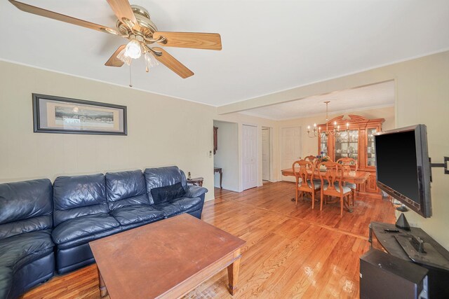 2772 Cypress Ave, East Meadow, NY 11554 - living room with light wood-style floors, a chandelier, a ceiling fan, and crown molding