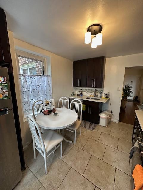 18-65 211th St Unit 5D, Bayside, NY 11360 - dining room with light tile patterned floors