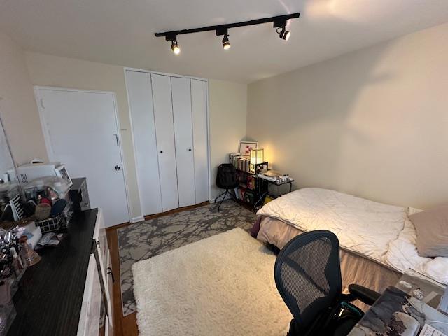 18-65 211th St Unit 5D, Bayside, NY 11360 - bedroom with rail lighting and a closet