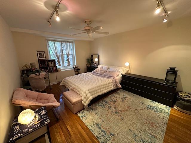 18-65 211th St Unit 5D, Bayside, NY 11360 - bedroom featuring rail lighting, wood finished floors, and ceiling fan