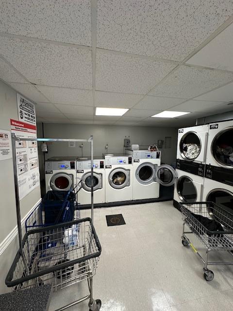 18-65 211th St Unit 5D, Bayside, NY 11360 - communal laundry room featuring stacked washer and clothes dryer, washing machine and dryer, and tile patterned floors