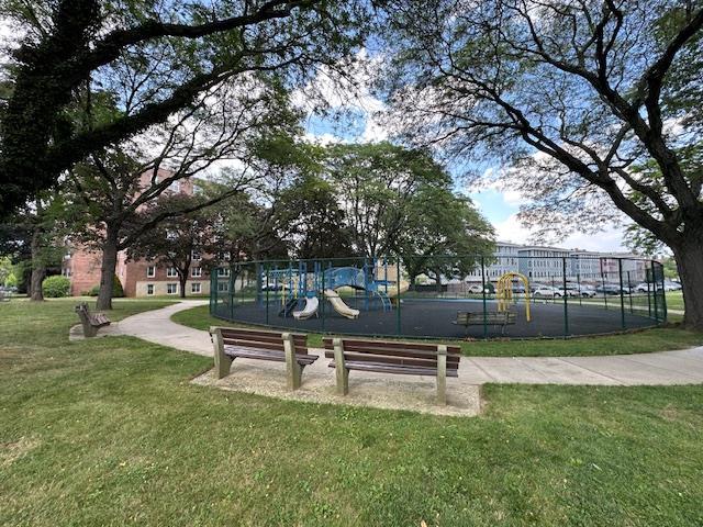 18-65 211th St Unit 5D, Bayside, NY 11360 - surrounding community featuring a lawn