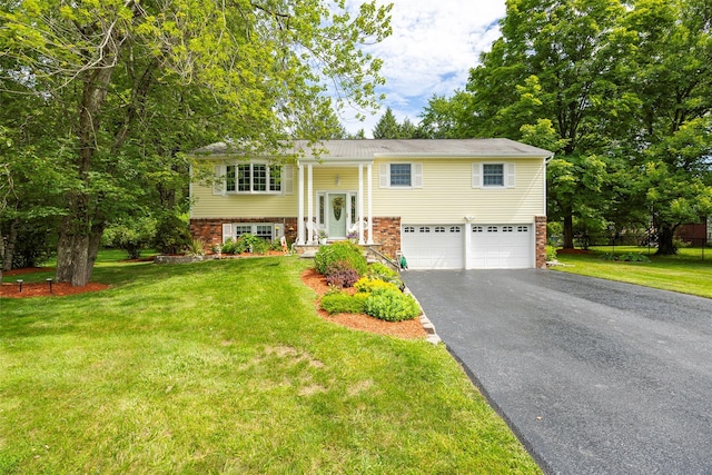 9 Malstorme Rd, Wappingers Falls, NY 12590 - split foyer home with asphalt driveway, a garage, and a front yard