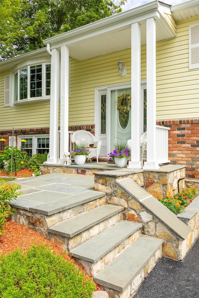 9 Malstorme Rd, Wappingers Falls, NY 12590 - view of exterior entry featuring covered porch and brick siding