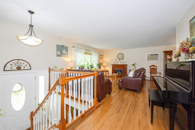 9 Malstorme Rd, Wappingers Falls, NY 12590 - entrance foyer with a wall unit AC, light wood finished floors, and a glass covered fireplace