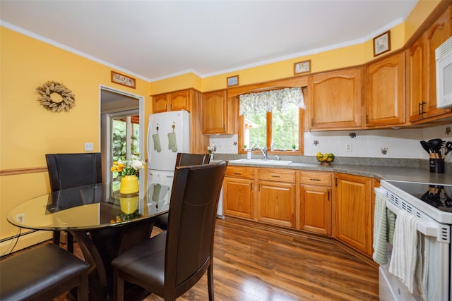 9 Malstorme Rd, Wappingers Falls, NY 12590 - kitchen featuring white appliances, brown cabinets, crown molding, dark wood-style floors, and decorative backsplash