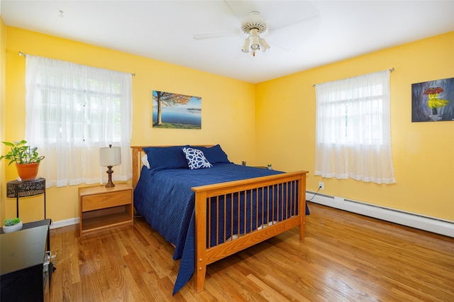 9 Malstorme Rd, Wappingers Falls, NY 12590 - bedroom featuring wood finished floors, a baseboard heating unit, and a ceiling fan