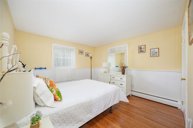 9 Malstorme Rd, Wappingers Falls, NY 12590 - bedroom with a baseboard heating unit and wood finished floors