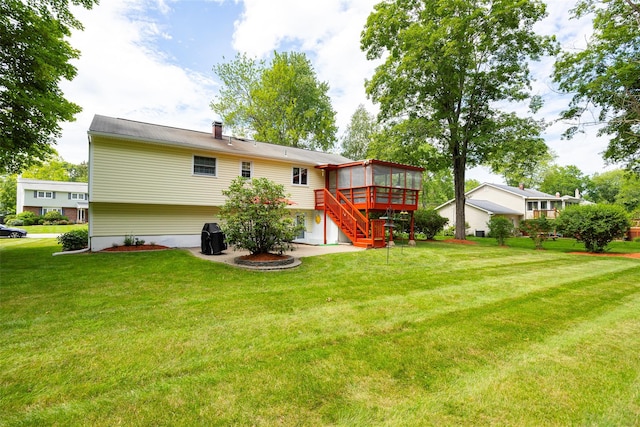 9 Malstorme Rd, Wappingers Falls, NY 12590 - rear view of property featuring a sunroom, a lawn, and stairway