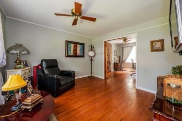 20 Wainwright St, Ronkonkoma, NY 11779 - living area with ceiling fan, wood finished floors, and ornamental molding