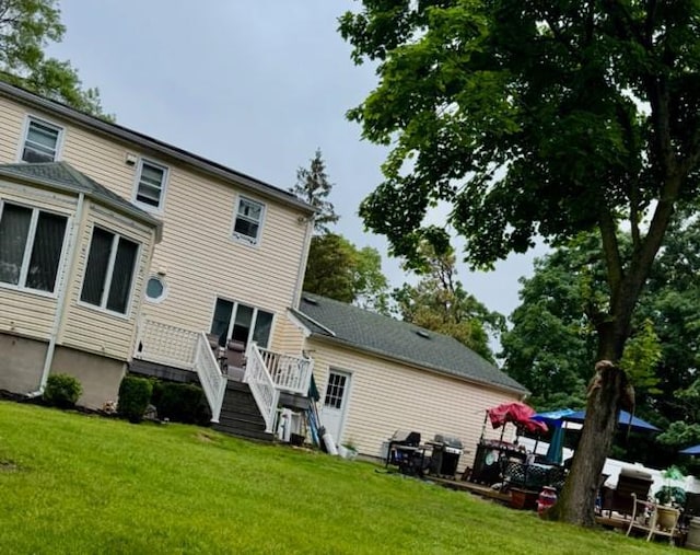 20 Wainwright St, Ronkonkoma, NY 11779 - rear view of house featuring a yard, stairway, and a wooden deck