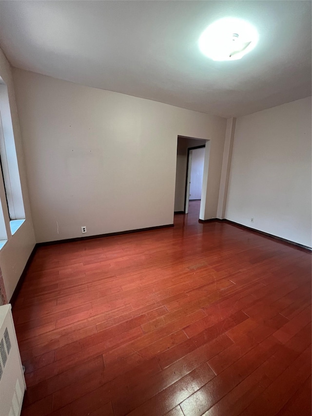 38-05 65th St Unit 2F, Woodside, NY 11377 - empty room with wood finished floors and baseboards