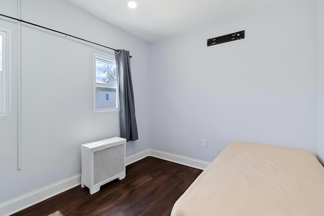 25-57 Mcintosh St, East Elmhurst, NY 11369 - unfurnished bedroom with dark wood finished floors, radiator, and recessed lighting