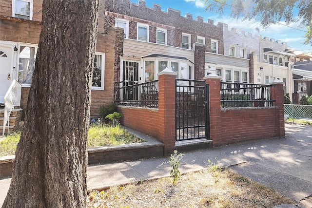25-57 Mcintosh St, East Elmhurst, NY 11369 - view of front of house featuring a fenced front yard, a gate, and a residential view